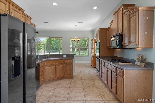 1918 W Crystal Mae Path, Lecanto, FL 34461 - kitchen with dark countertops, a chandelier, a sink, and black appliances