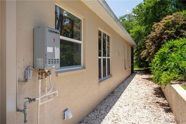 1918 W Crystal Mae Path, Lecanto, FL 34461 - view of side of home with stucco siding and water heater