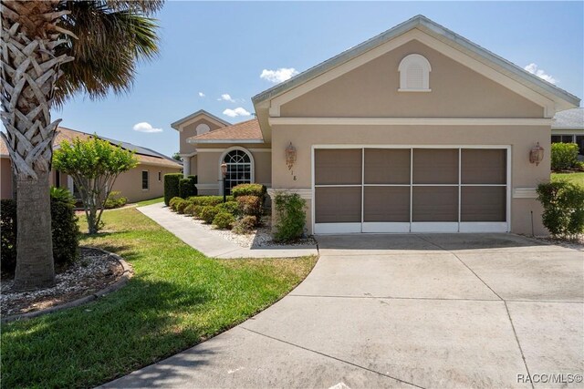 1918 W Crystal Mae Path, Lecanto, FL 34461 - view of front of property with a garage, stucco siding, driveway, and a front yard