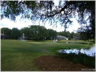 1918 W Crystal Mae Path, Lecanto, FL 34461 - view of community featuring a water view, a yard, and golf course view