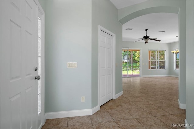 1918 W Crystal Mae Path, Lecanto, FL 34461 - foyer featuring a ceiling fan, visible vents, arched walkways, light tile patterned floors, and baseboards