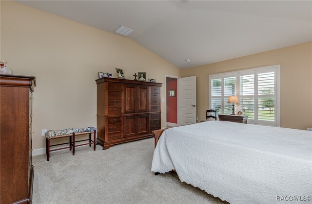 carpeted bedroom featuring vaulted ceiling