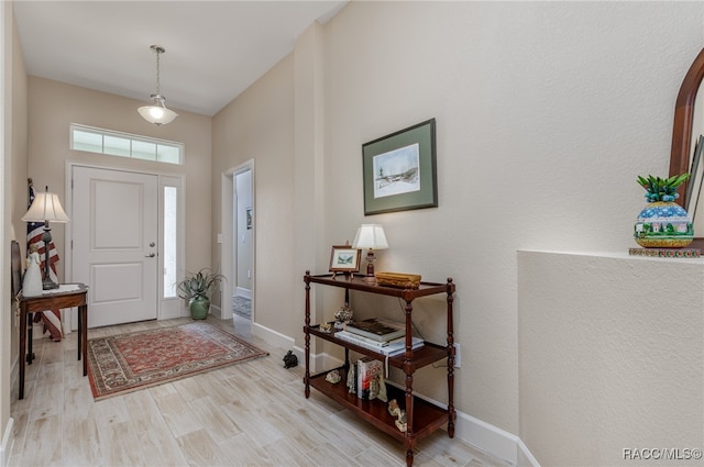 foyer entrance with light hardwood / wood-style floors