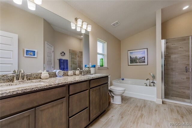 full bathroom featuring vanity, wood-type flooring, independent shower and bath, toilet, and lofted ceiling