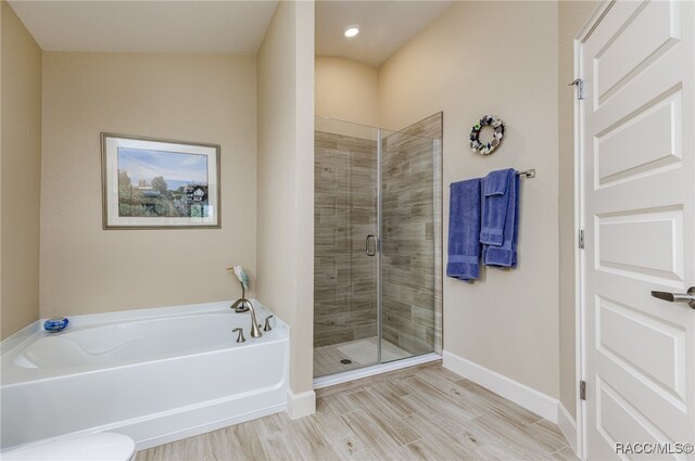 bathroom with plus walk in shower and wood-type flooring