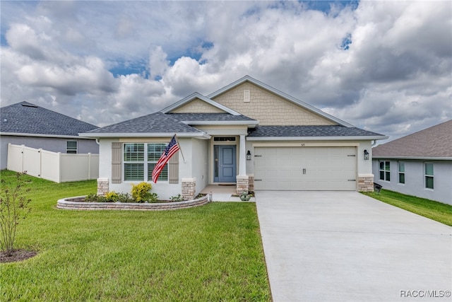 view of front of home with a garage and a front lawn