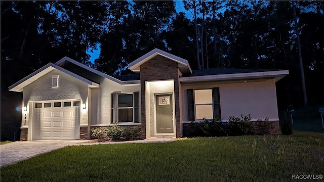 6342 E Grayson St, Inverness, FL 34452 - ranch-style house featuring stone siding, an attached garage, decorative driveway, stucco siding, and a front lawn