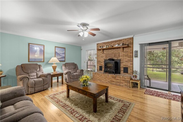 1179 N Point Lonesome Rd, Inverness, FL 34453 - living room featuring a wood stove, a ceiling fan, ornamental molding, healthy amount of natural light, and light wood finished floors