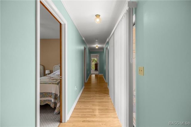 1179 N Point Lonesome Rd, Inverness, FL 34453 - corridor featuring light wood-style floors, crown molding, and baseboards