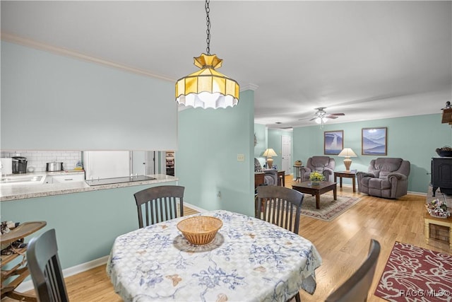 1179 N Point Lonesome Rd, Inverness, FL 34453 - dining area featuring ceiling fan, light wood-style flooring, and ornamental molding