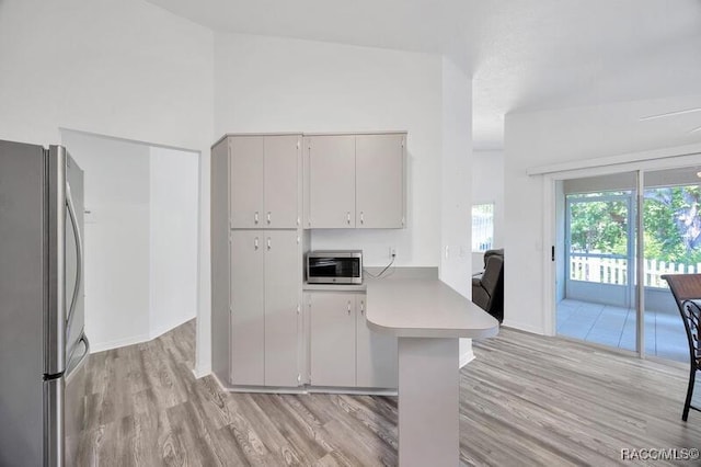 2885 N Attebury Pt, Hernando, FL 34442 - kitchen with stainless steel appliances, light wood finished floors, light countertops, and a peninsula