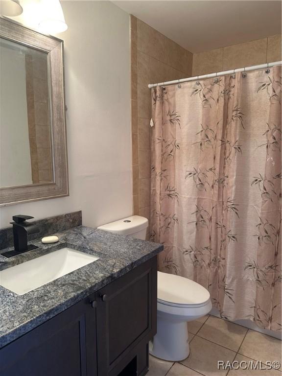 bathroom featuring tile patterned floors, vanity, and toilet