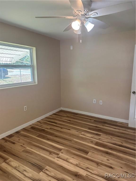 unfurnished room featuring wood-type flooring and ceiling fan