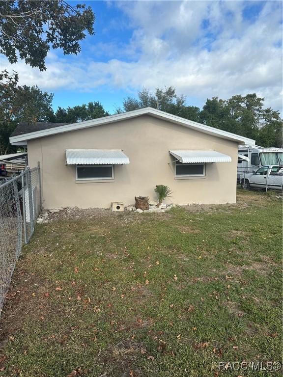 view of side of home featuring a yard