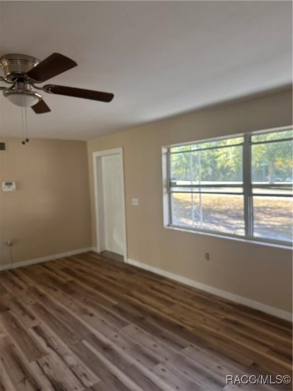 unfurnished room featuring ceiling fan and dark hardwood / wood-style floors