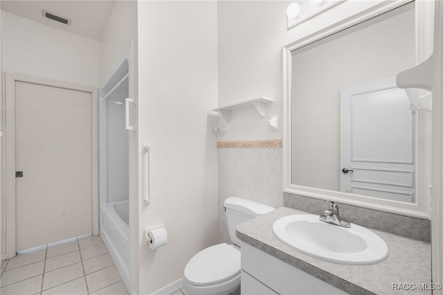 bathroom with tile patterned floors, vanity, tile walls, and toilet