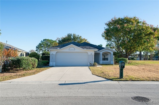 single story home featuring a garage and a front lawn