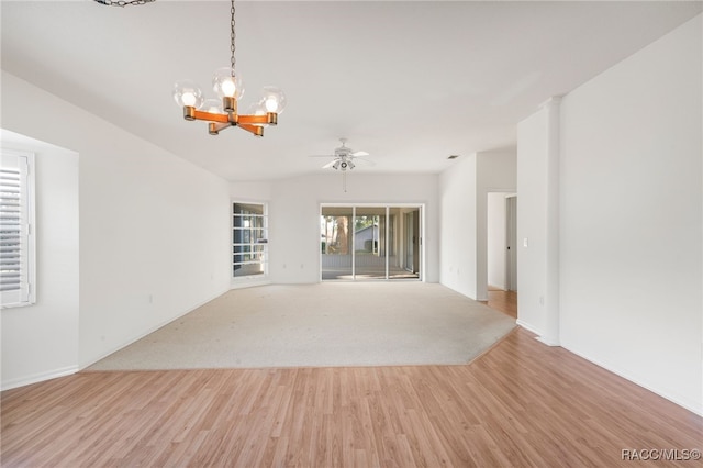 unfurnished living room featuring light hardwood / wood-style flooring and ceiling fan with notable chandelier