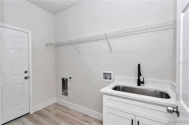 laundry room featuring sink, cabinets, light wood-type flooring, washer hookup, and hookup for an electric dryer