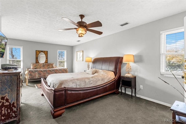 carpeted bedroom featuring multiple windows, ceiling fan, and a textured ceiling