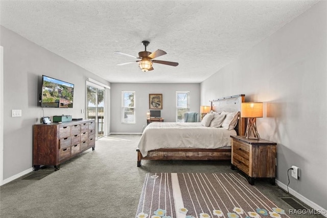 carpeted bedroom with access to exterior, a textured ceiling, and ceiling fan