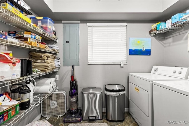 clothes washing area featuring electric panel and washer and dryer