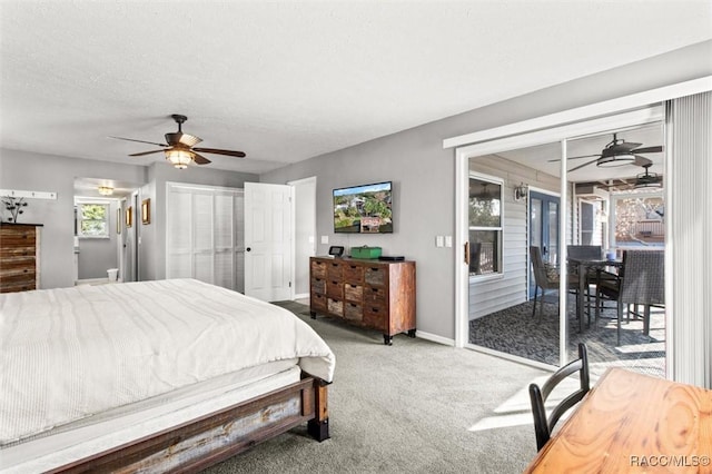 bedroom with access to exterior, ceiling fan, a textured ceiling, and carpet