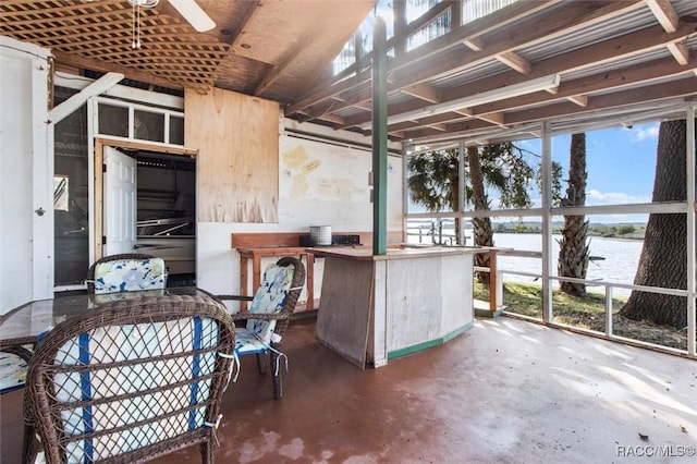 interior space with ceiling fan and a water view