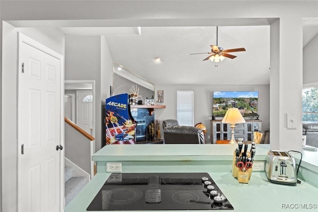 kitchen with ceiling fan, lofted ceiling, and black electric cooktop