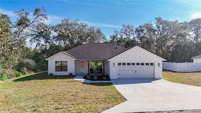 view of front of property featuring a garage and a front yard