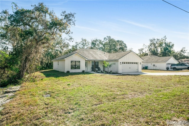 ranch-style home featuring a garage and a front lawn