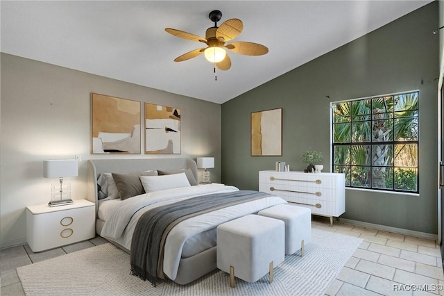 bedroom with ceiling fan, light tile patterned floors, and vaulted ceiling