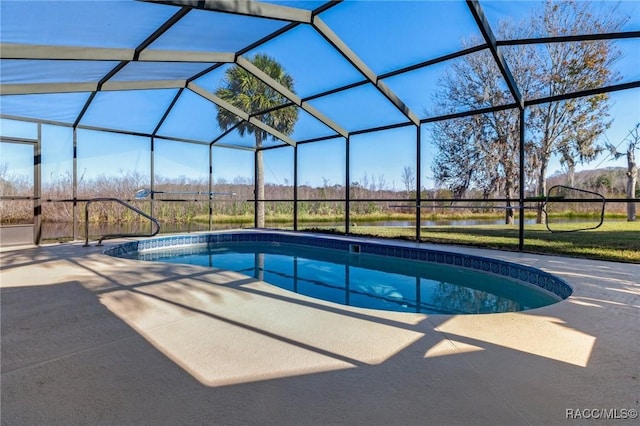 view of pool featuring glass enclosure and a patio area