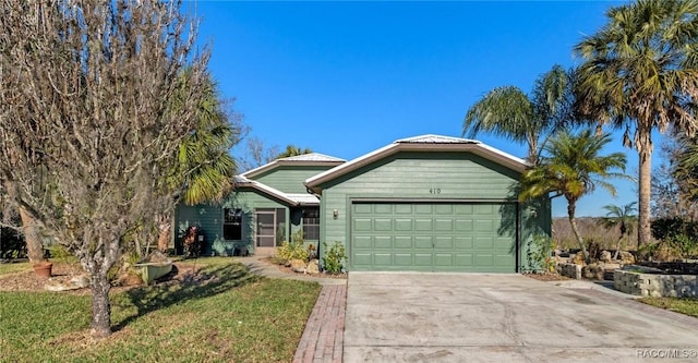 single story home with a garage and a front lawn