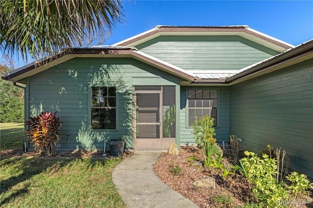 entrance to property with a yard