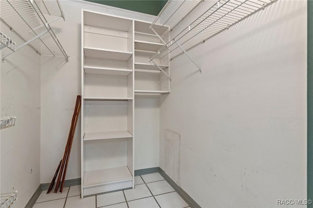 spacious closet featuring light tile patterned floors