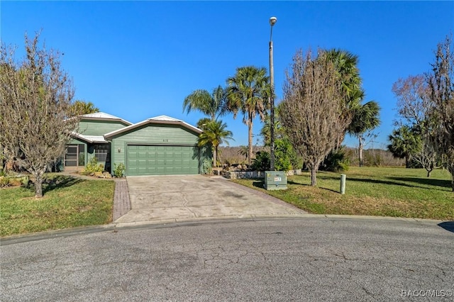 single story home featuring a garage and a front lawn