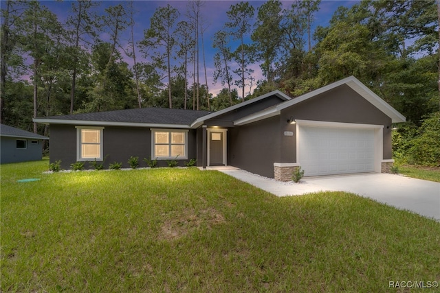 ranch-style home featuring a yard and a garage