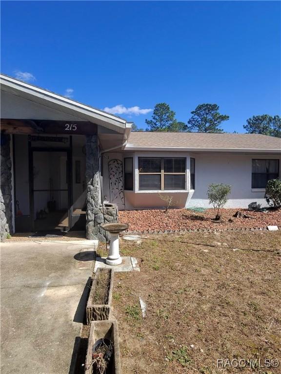 single story home featuring stucco siding