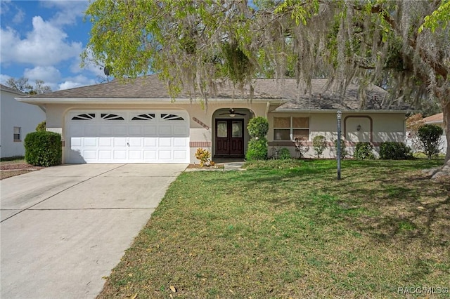 single story home featuring a garage, a front lawn, concrete driveway, and stucco siding