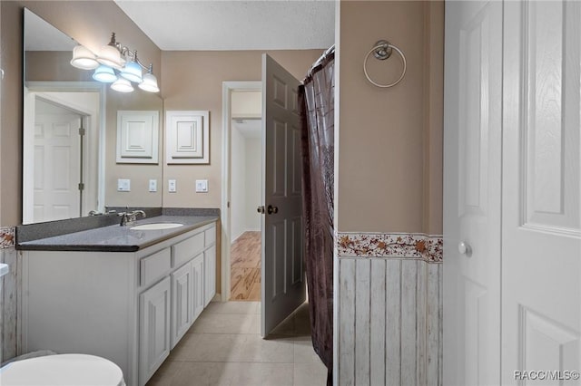 full bath with vanity and tile patterned floors