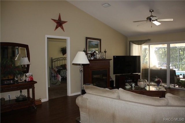 living room featuring lofted ceiling, dark wood-type flooring, and ceiling fan