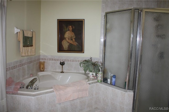 bathroom with shower with separate bathtub