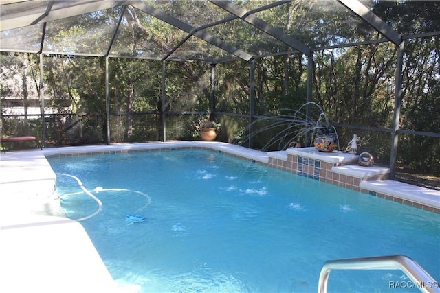 view of pool with a lanai and pool water feature