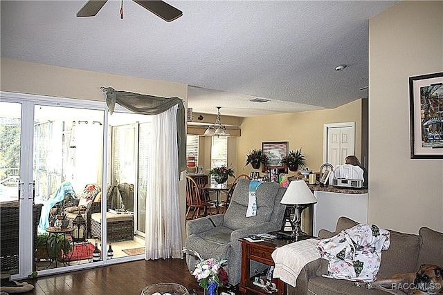 living room with dark wood-type flooring and ceiling fan