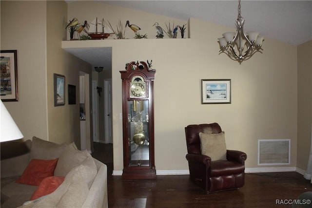 living area with dark hardwood / wood-style floors and an inviting chandelier