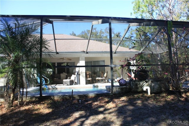 back of house featuring a patio area, ceiling fan, and glass enclosure