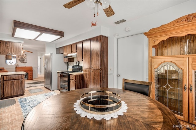 dining room with ceiling fan and visible vents