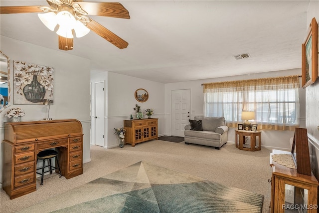 carpeted living room with a ceiling fan, visible vents, and baseboards