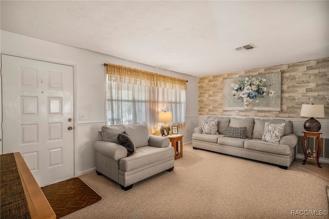 living area featuring visible vents and baseboards